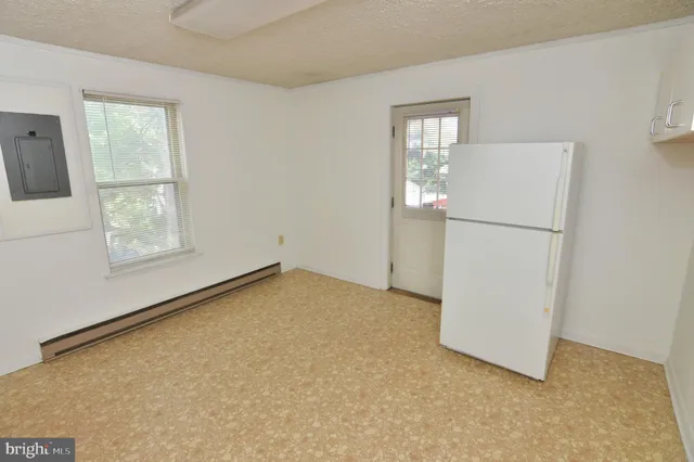a view of a kitchen with refrigerator and a sink