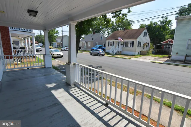 a view of balcony with wooden floor and outdoor seating