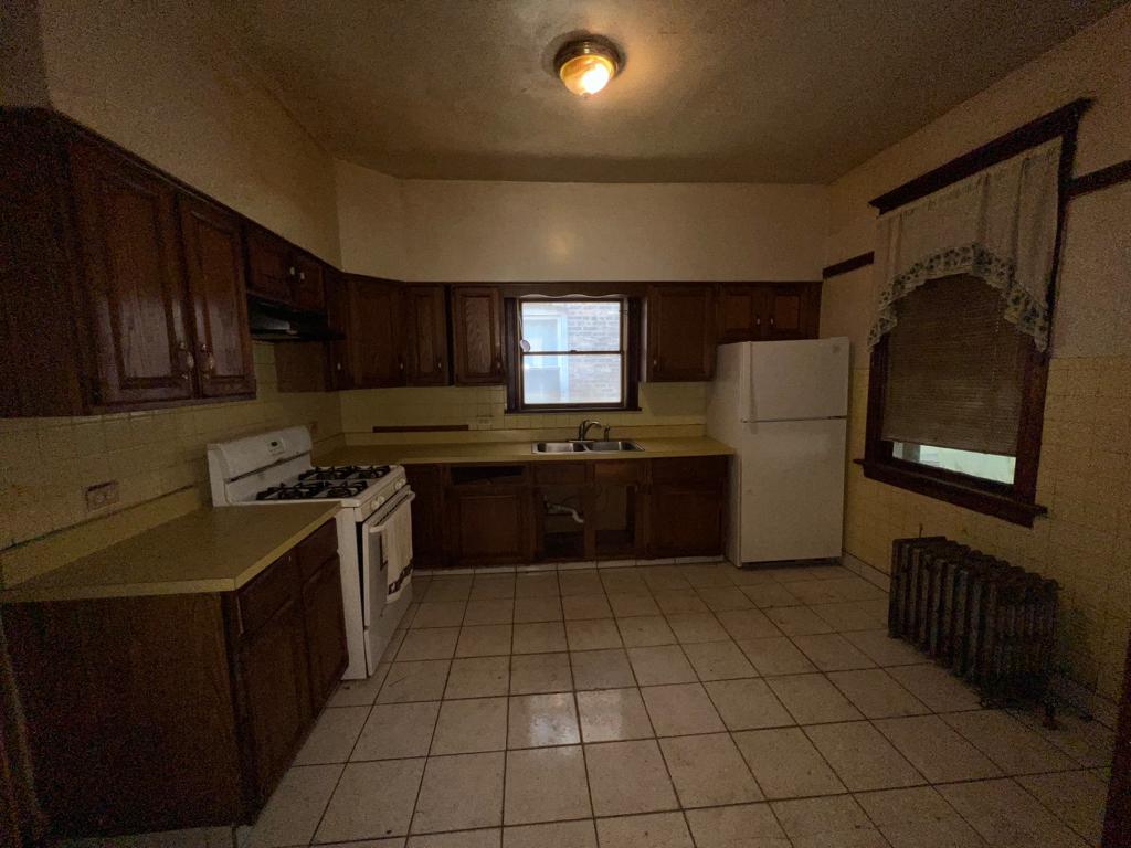 7348 South Sangamon Street Chicago, IL 60621 - Photo 17 of 29 a kitchen with a cabinets and steel stainless steel appliances