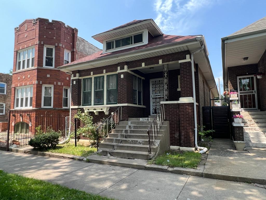 7348 South Sangamon Street Chicago, IL 60621 - Photo 2 of 29 a front view of a house with a yard
