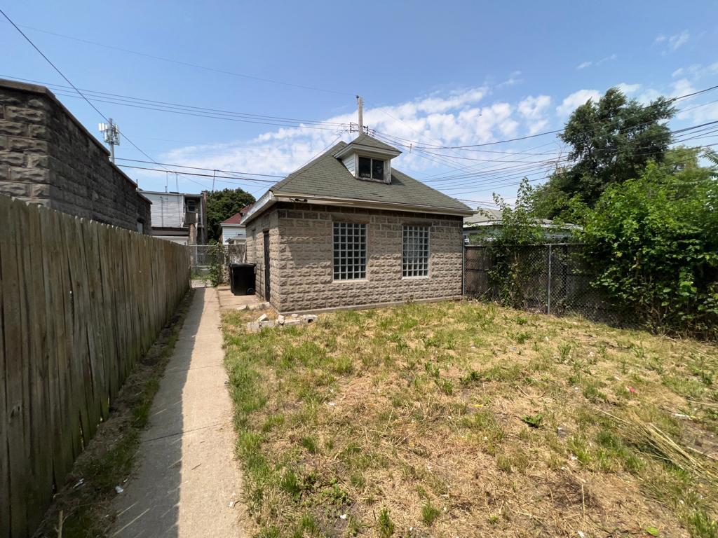 7348 South Sangamon Street Chicago, IL 60621 - Photo 28 of 29 a front view of a house with a yard