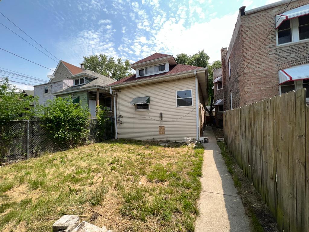 7348 South Sangamon Street Chicago, IL 60621 - Photo 29 of 29 a house with trees in front of it
