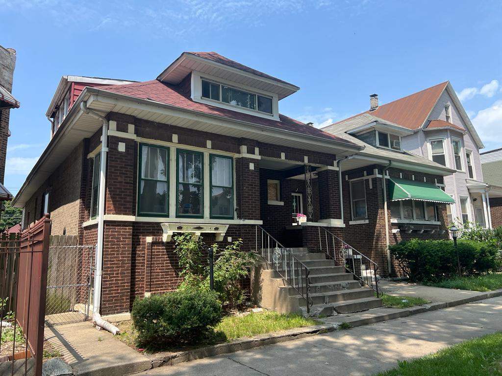 7348 South Sangamon Street Chicago, IL 60621 - Photo 3 of 29 front view of a house with a small yard