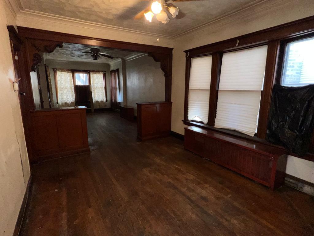 7348 South Sangamon Street Chicago, IL 60621 - Photo 6 of 29 an empty room with wooden floor and windows