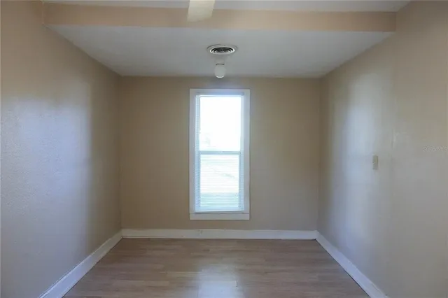 a view of an empty room with a window