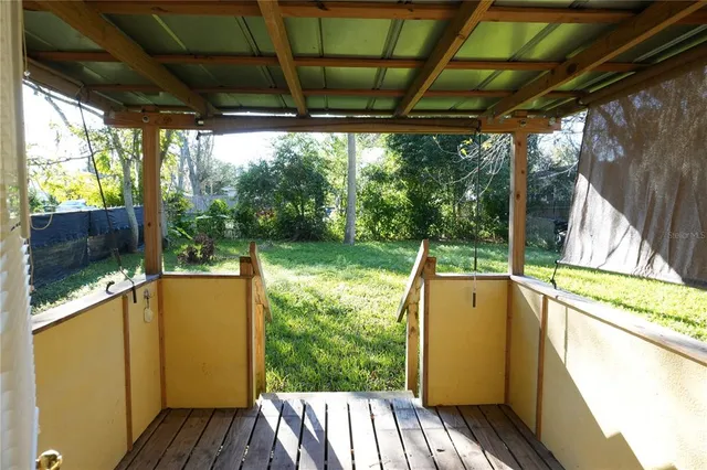 a view of a porch with wooden floor