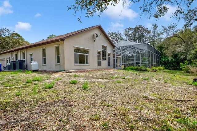 a view of a kitchen with kitchen island a sink stainless steel appliances and cabinets