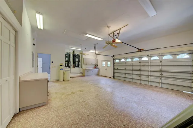 an empty room with closet and a ceiling fan