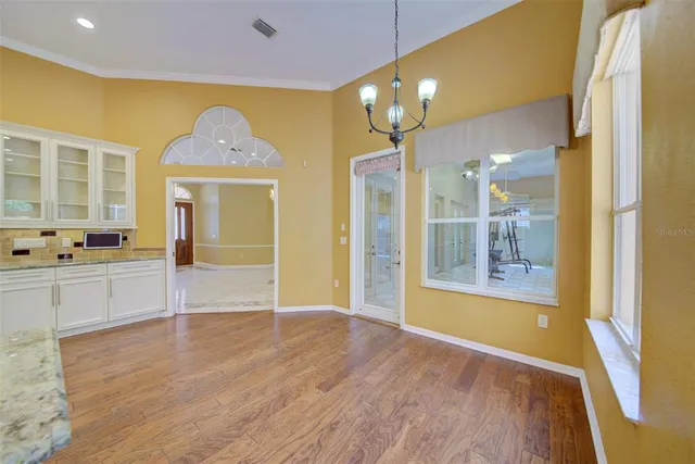 a front view of a house with a yard and trees
