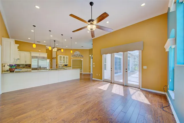 a view of a backyard with a floor to ceiling window and wooden fence