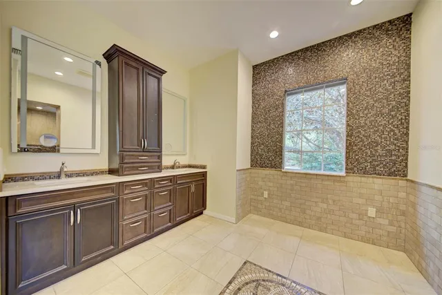 a front view of house with yard and trees around