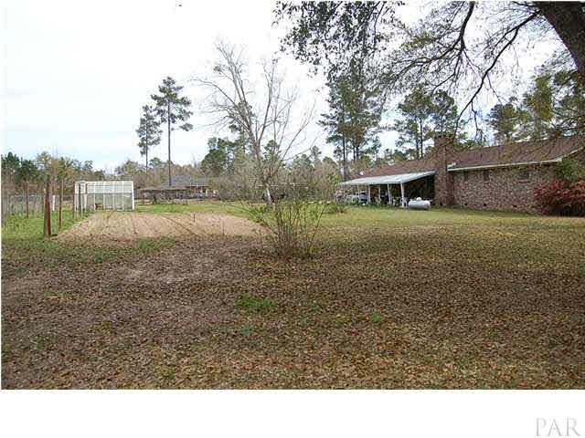 7355 Beulah Road Pensacola, FL 32526 - Photo 10 of 13 View of back of home, green house and arbor