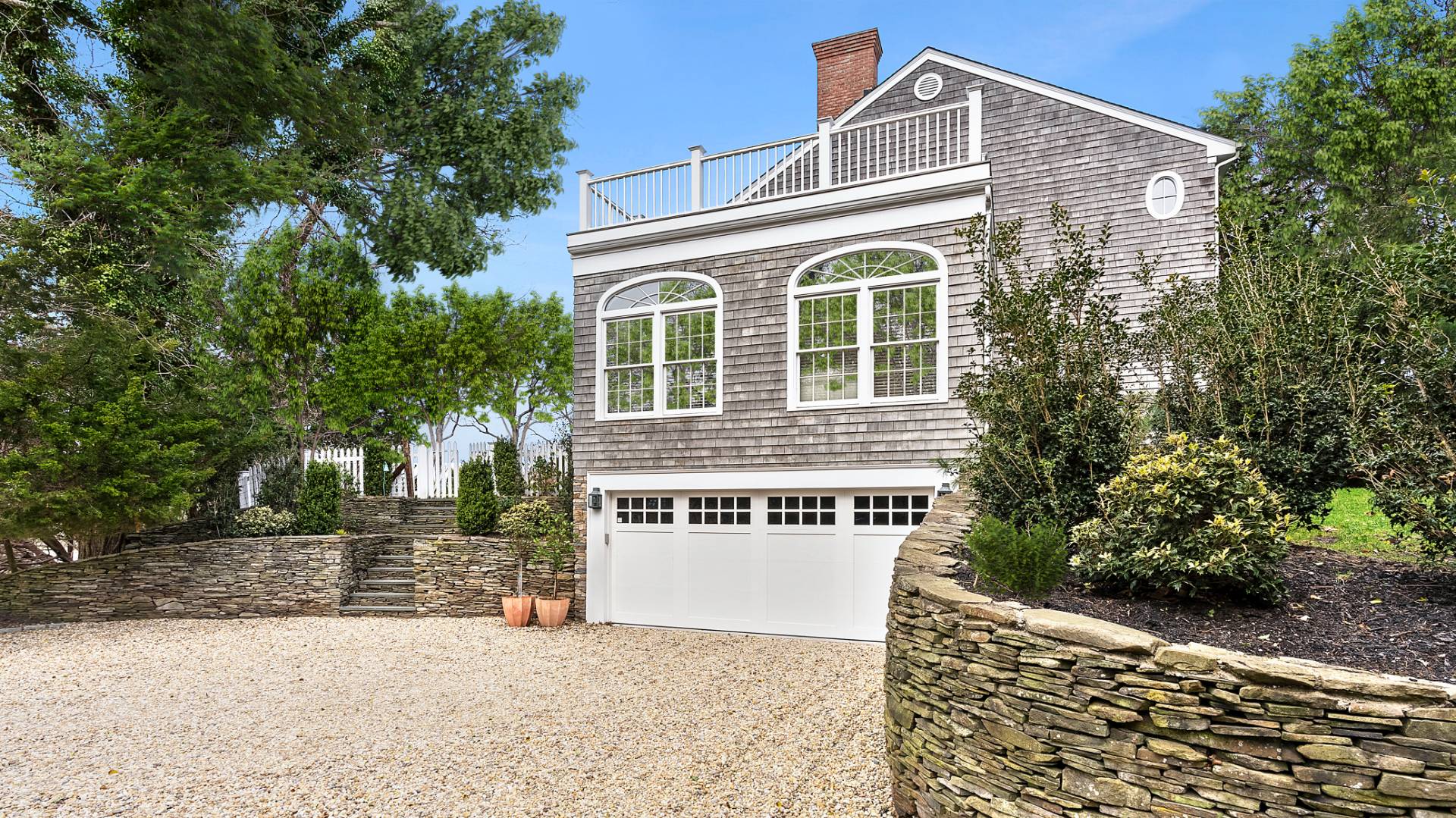 43 Thanet Way East Hampton, NY 11937 - Photo 32 of 34 a front view of a house with a garage