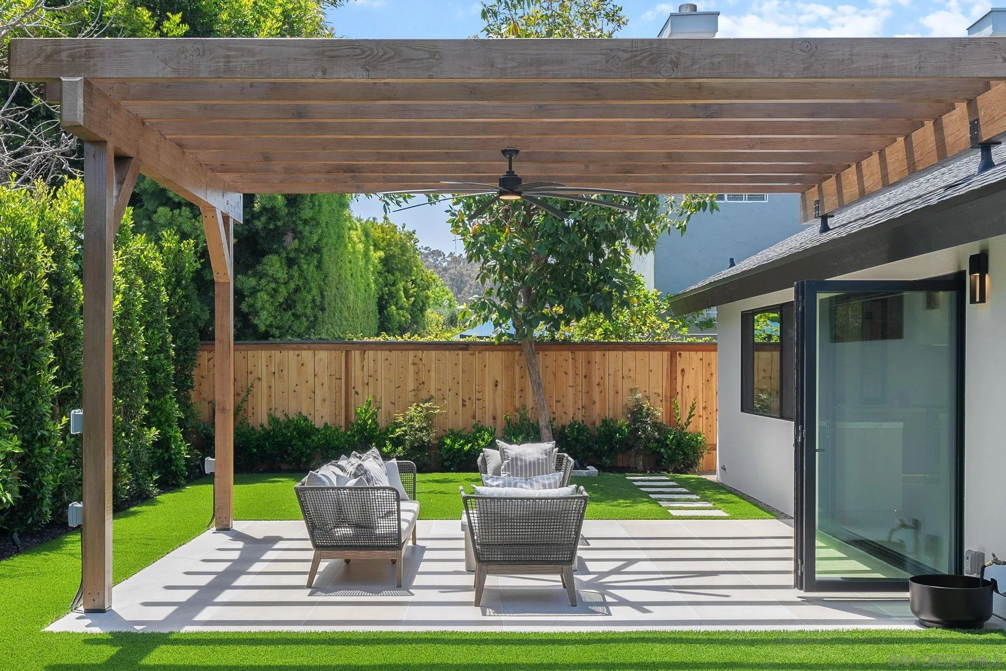 3835 Via Reposo Rancho Santa Fe, CA 92091 - Photo 14 of 34 a patio with table and chairs potted plants and floor to ceiling window and garden