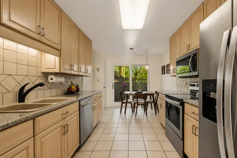 a kitchen with stainless steel appliances a sink stove and cabinets