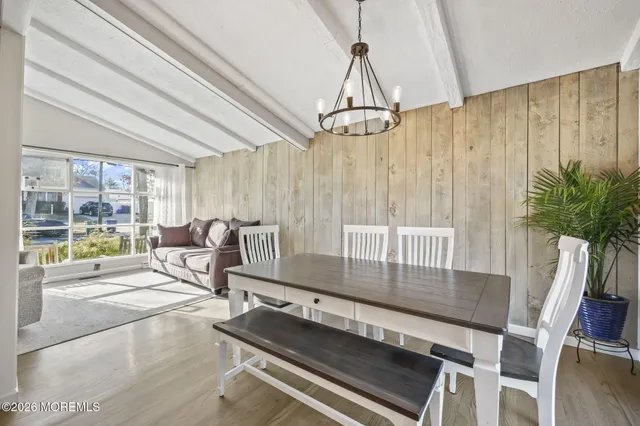 a dining room with furniture and a chandelier