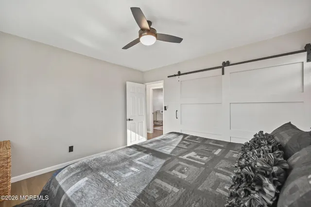 a bed room with a bed and a ceiling fan