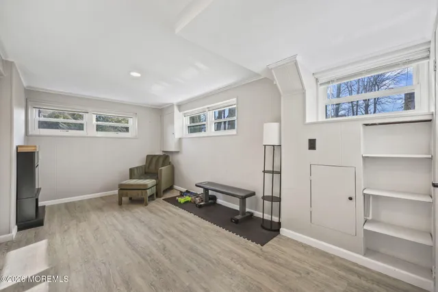 a living room with furniture gym equipment and a window