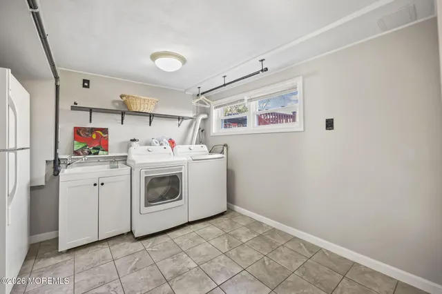 a utility room with cabinets washer and dryer