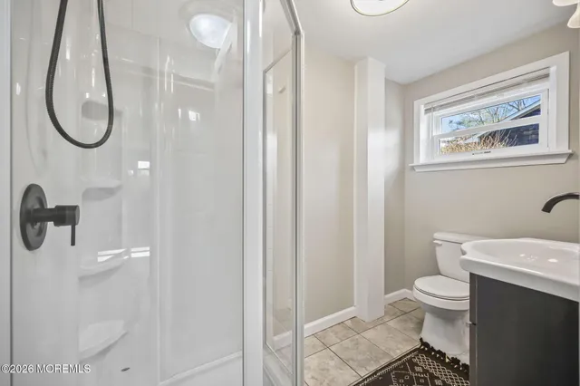 a bathroom with a toilet a sink and a mirror