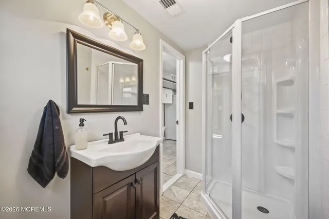 a bathroom with a sink vanity and a mirror