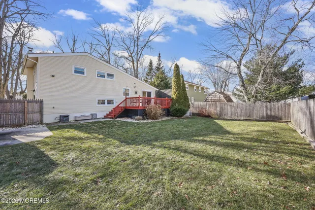 a backyard of a house with table and chairs