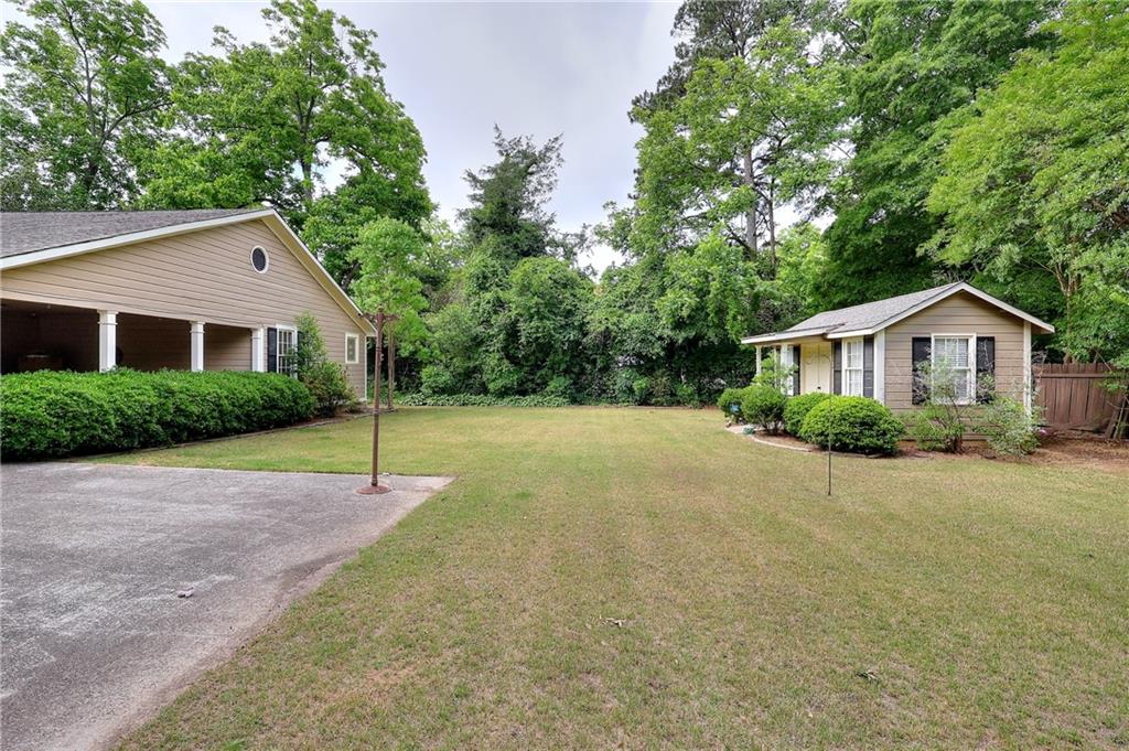 317 North Cherokee Road Social Circle, GA 30025 - Photo 5 of 32 a house with green field