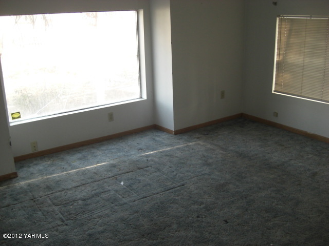 10703 Hughes Road Yakima, WA 98903 - Photo 8 of 8 a view of an empty room with a window
