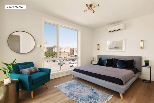 a bed room with a bed and a chair