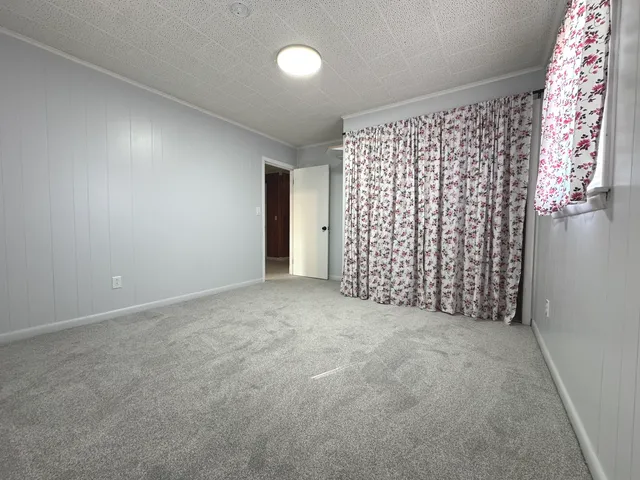 an empty room with windows and entrance