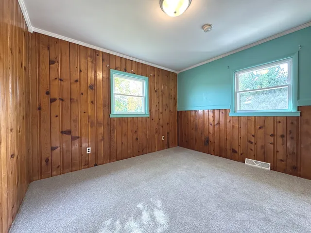 an empty room with closet and wooden floor