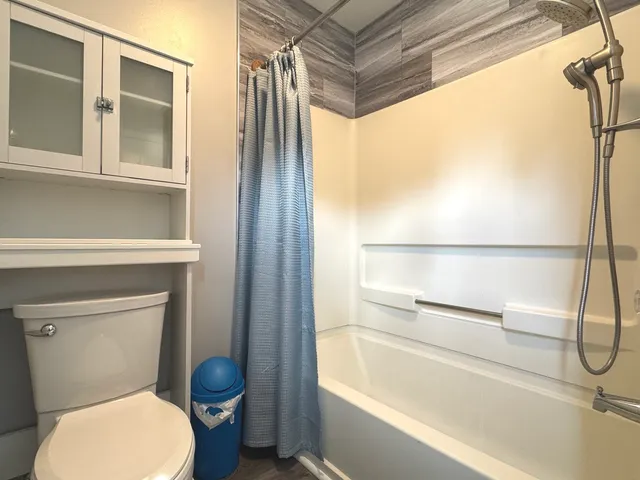 a bathroom with a sink and mirror with toilet