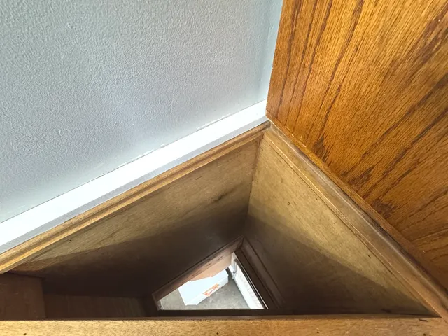 a view of a hallway with wooden shelves