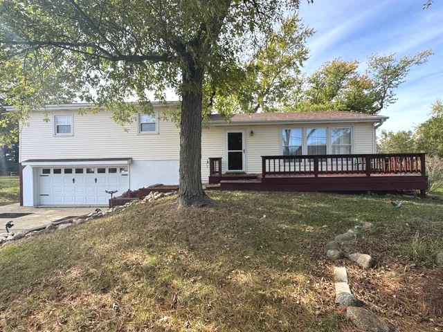 a view of a house with a yard and tree