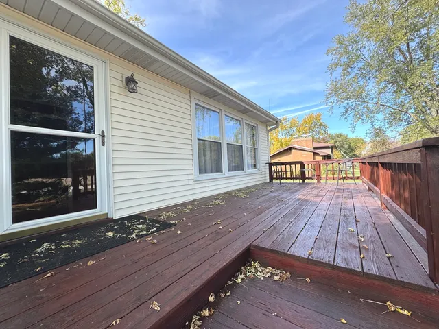 a view of backyard with a deck and wooden floor