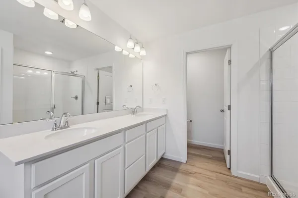 a bathroom with a double vanity sink and a mirror
