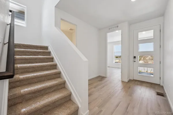 a view of an entryway with wooden floor