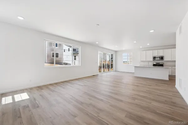 a view of kitchen and hall with wooden floor and a kitchen