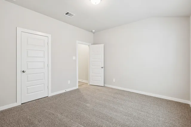 an empty room with closet area