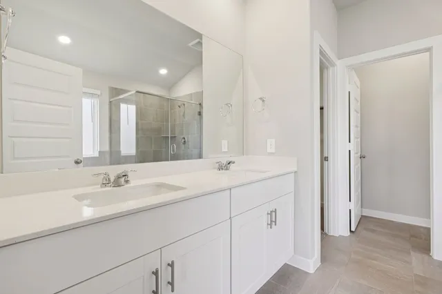 a bathroom with double sink and a mirror