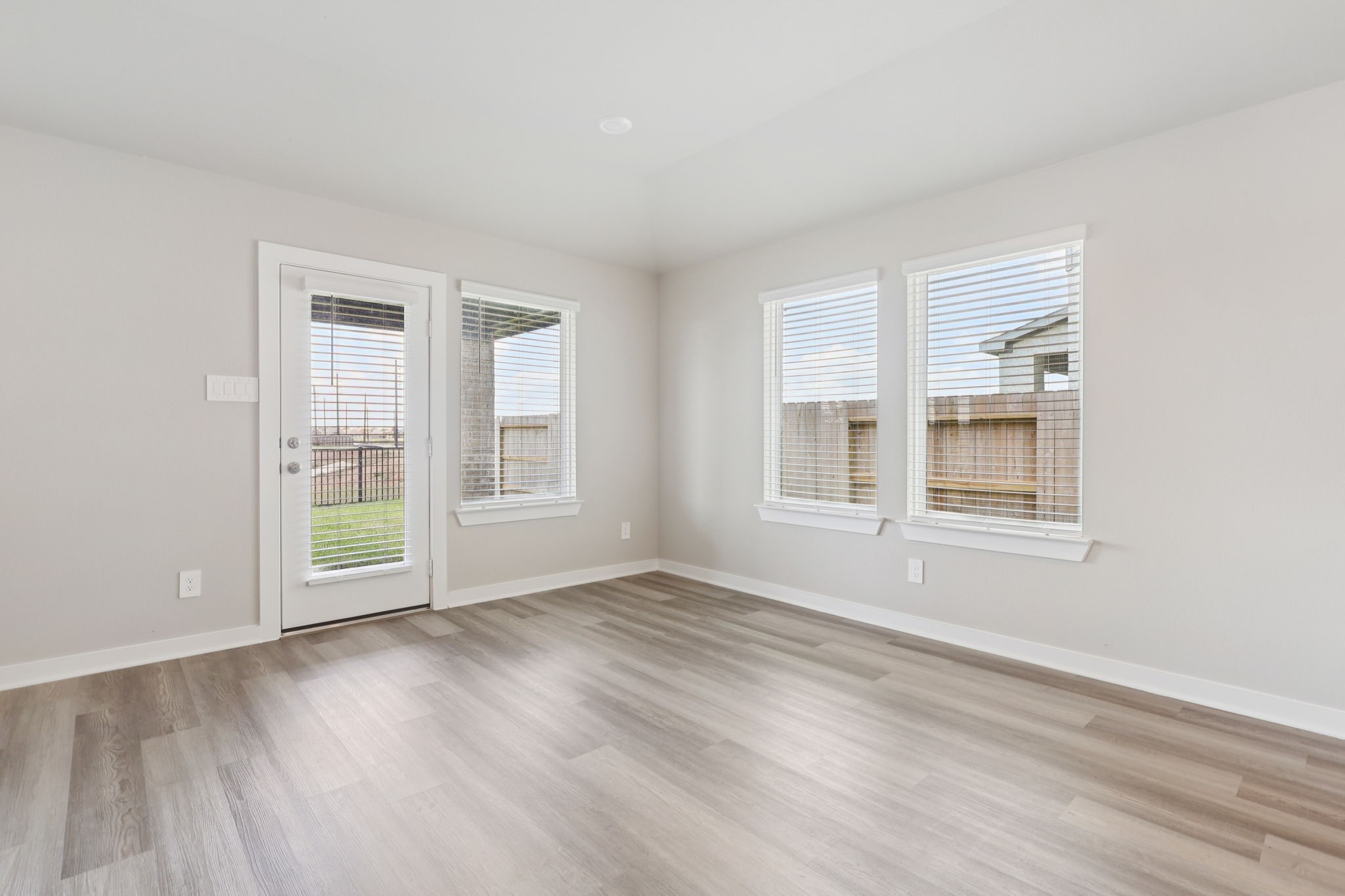 2639 Clapbread Lane Rosenberg, TX 77471 - Photo 9 of 31 a view of an empty room with wooden floor and a window