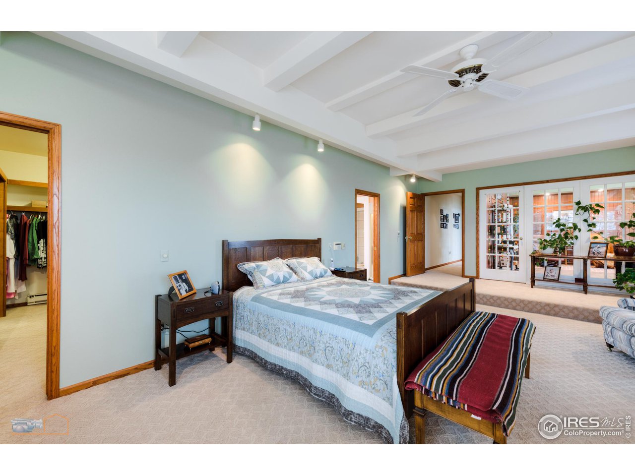 10024 Lookout Road Lafayette, CO 80026 - Photo 15 of 37 Primary Bedroom with walk in closet looking toward sun-room French-doors.