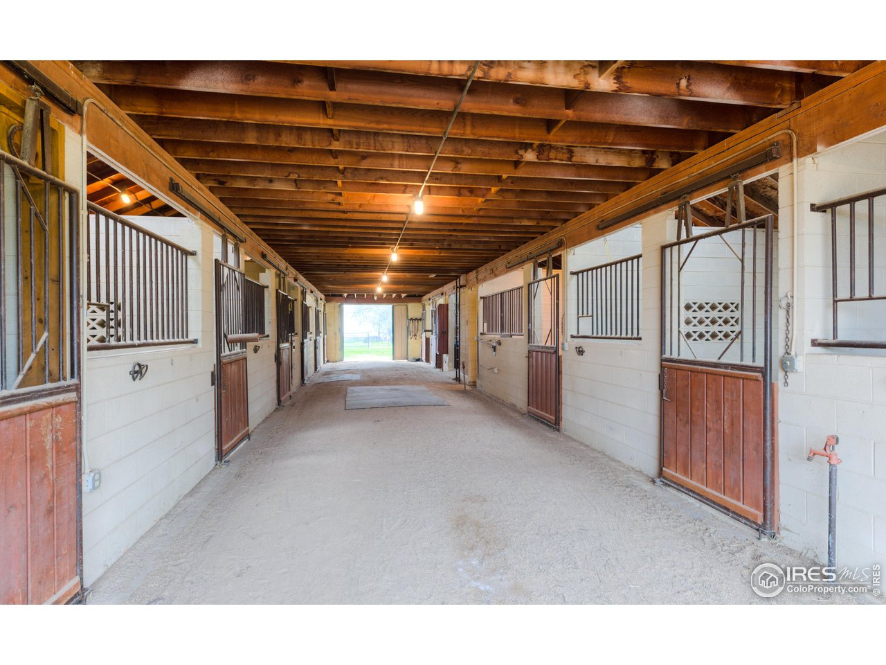 10024 Lookout Road Lafayette, CO 80026 - Photo 22 of 37 North Barn interior. 10 stalls, 2 tack rooms, office, and hay loft.