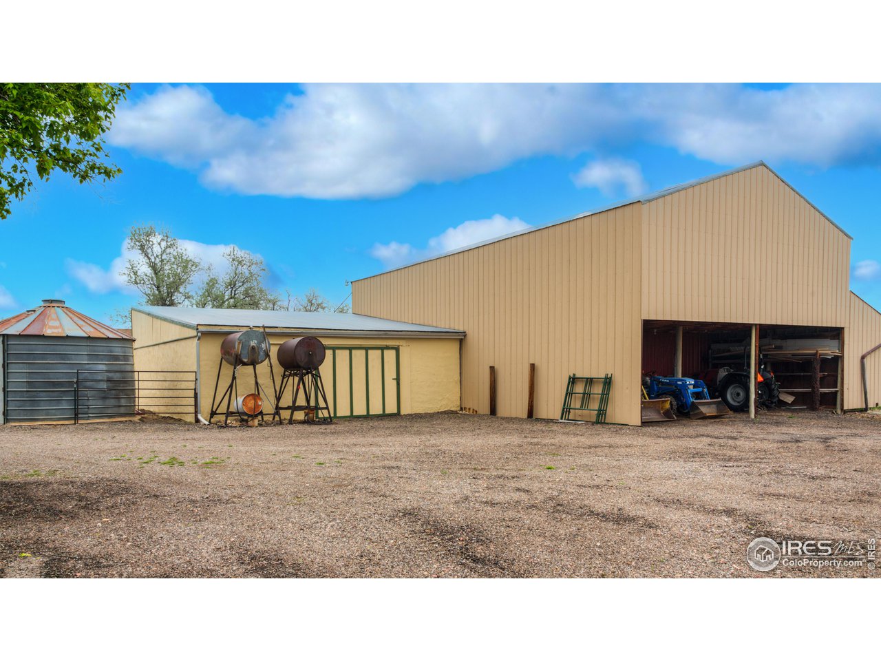 10024 Lookout Road Lafayette, CO 80026 - Photo 26 of 37 Equipment storage with workshop/wood storage barn and round silo to the left.