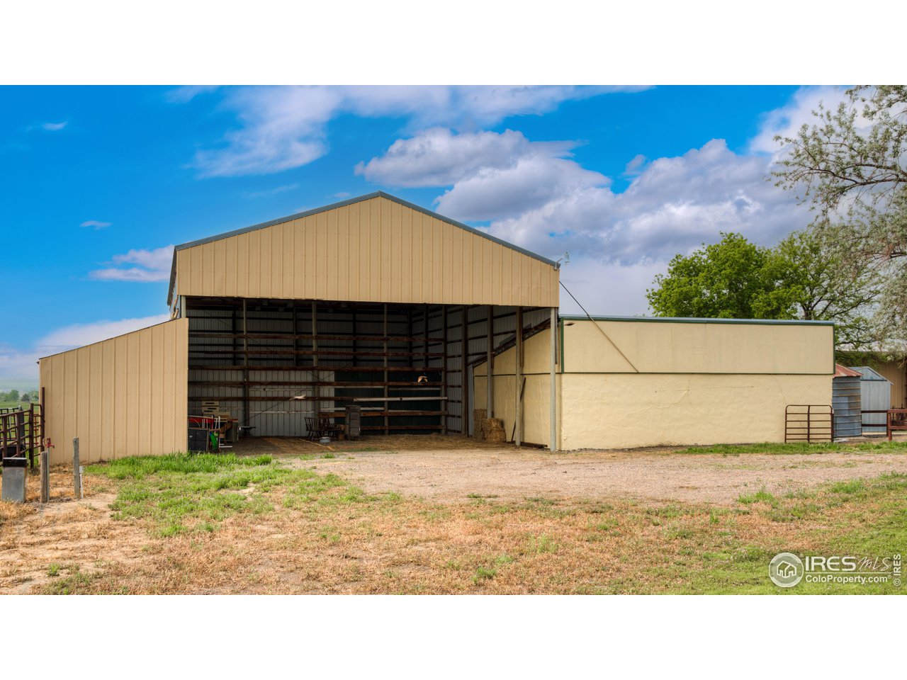 10024 Lookout Road Lafayette, CO 80026 - Photo 27 of 37 Covered Hay Storage barn. Back of workshop/wood storage on the right; covered shelters on the left.