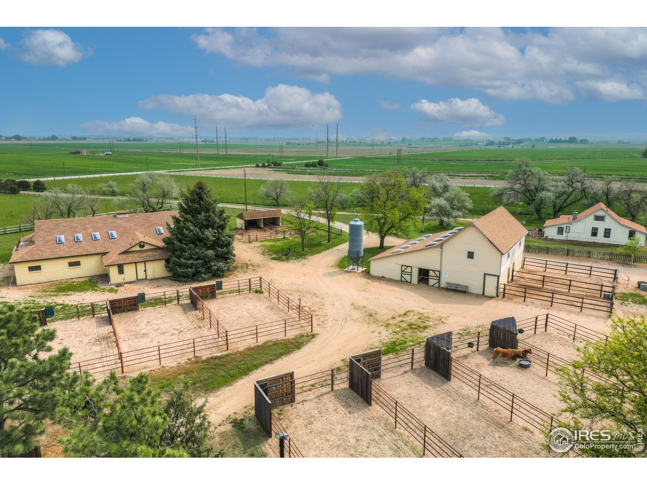 10024 Lookout Road Lafayette, CO 80026 - Photo 34 of 37 North Barn on the left, South barn on the right-center, ADU far right, and turnout paddocks