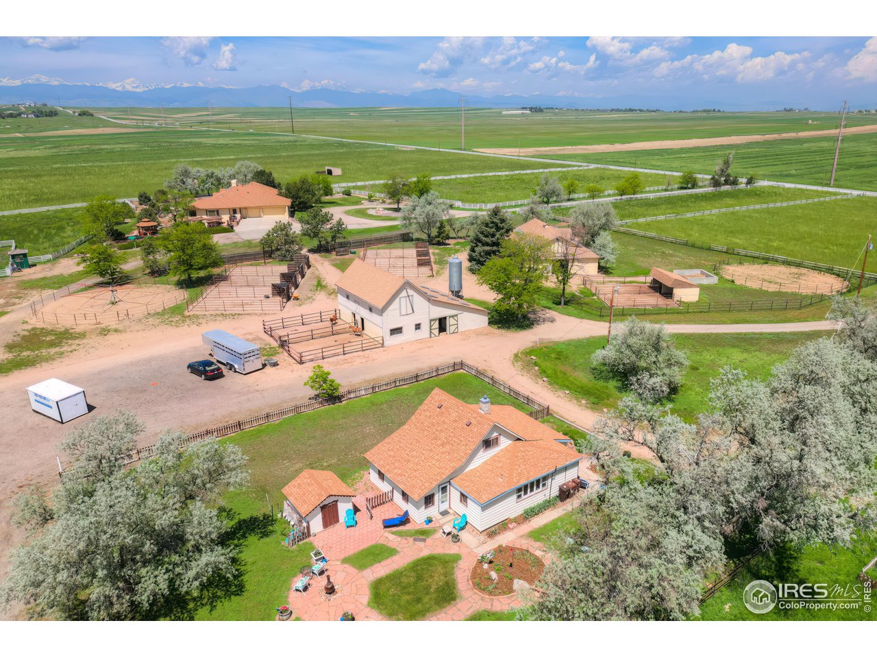10024 Lookout Road Lafayette, CO 80026 - Photo 35 of 37 Aerial looking west. ADU in foreground, south barn above it, main residence above that.