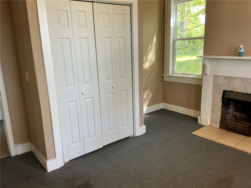 11 Humbert Street Seneca, SC 29678 - Photo 13 of 14 This inviting bedroom features a cozy fireplace, closet storage, and abundant natural light.