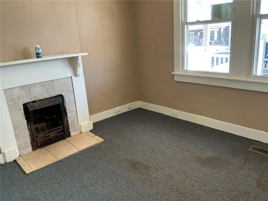 11 Humbert Street Seneca, SC 29678 - Photo 14 of 14 This cozy living space features a charming fireplace, perfect for creating a warm and inviting atmosphere.