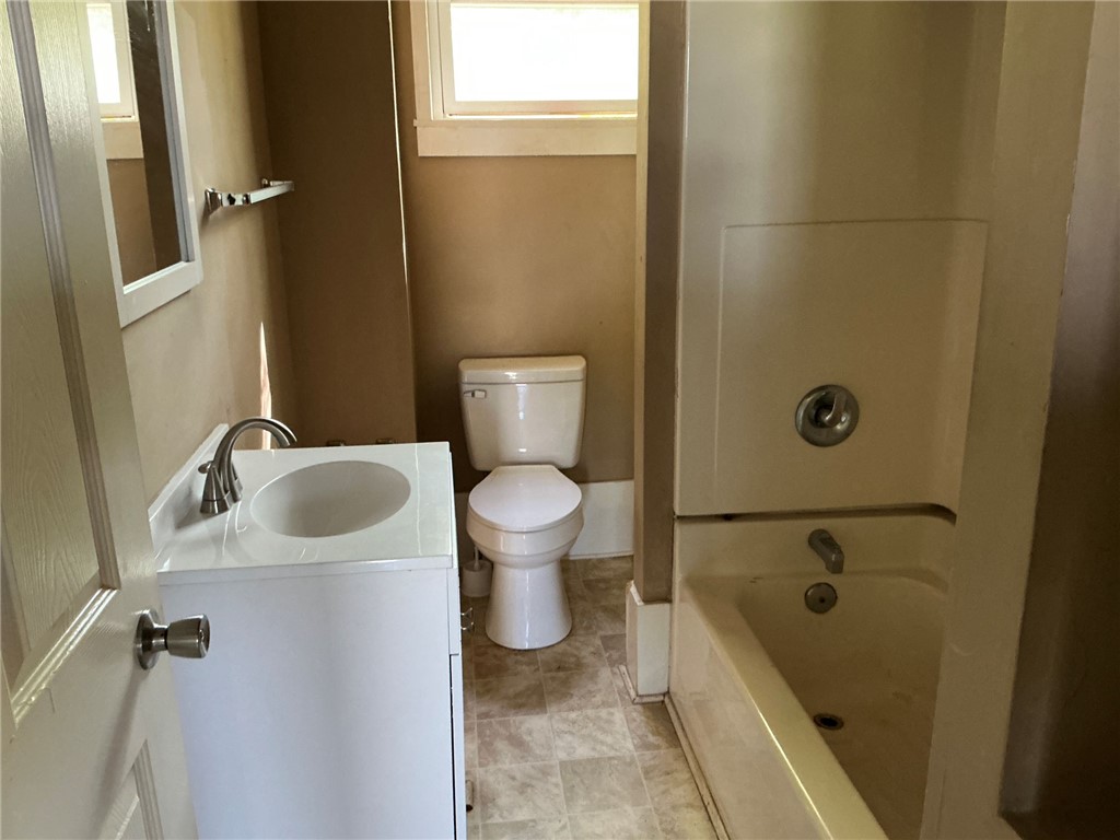 11 Humbert Street Seneca, SC 29678 - Photo 7 of 14 This bathroom features a sleek vanity, a toilet, and a combined tub and shower.